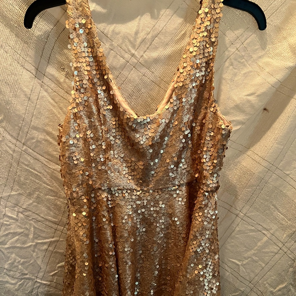 Metallic gold sequin cocktail dress. Tulle trim at the bottom. Side zipper.